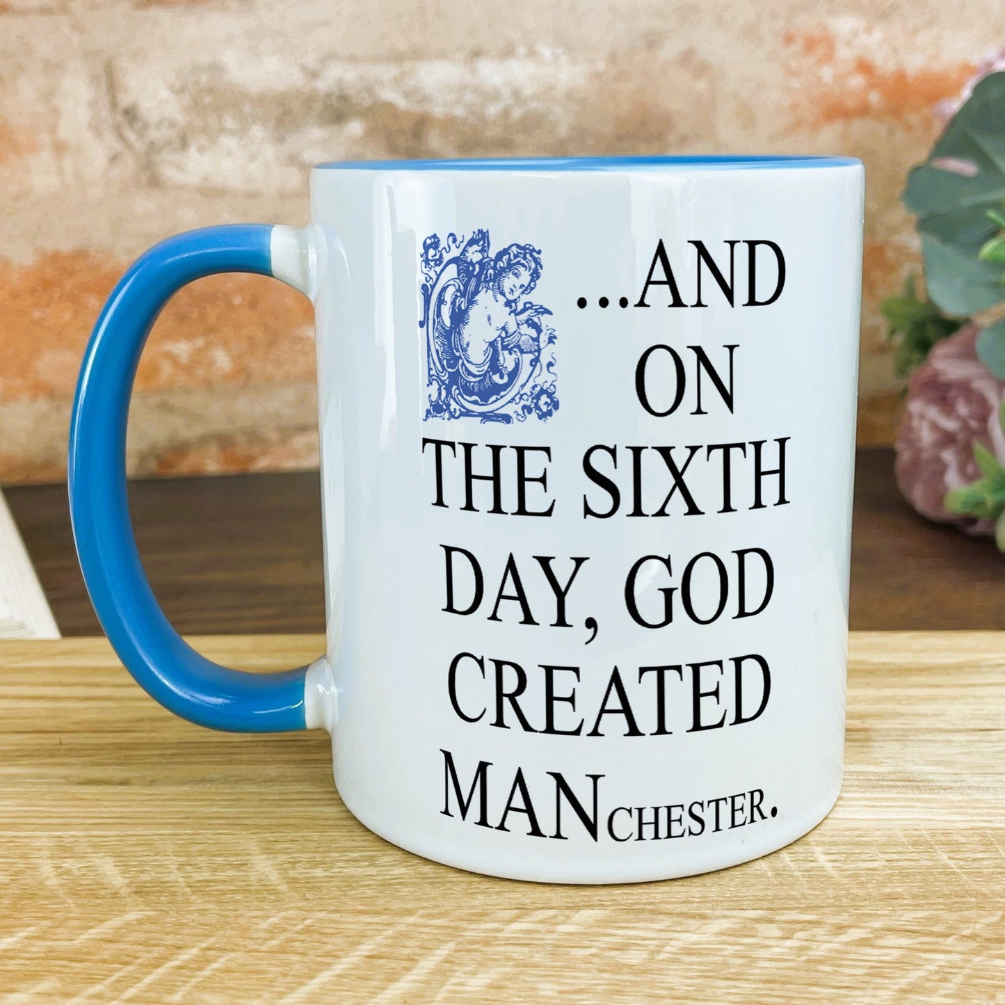 a blue and white mug sitting on top of a wooden table