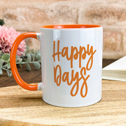 a white and orange coffee mug with the words happy days on it