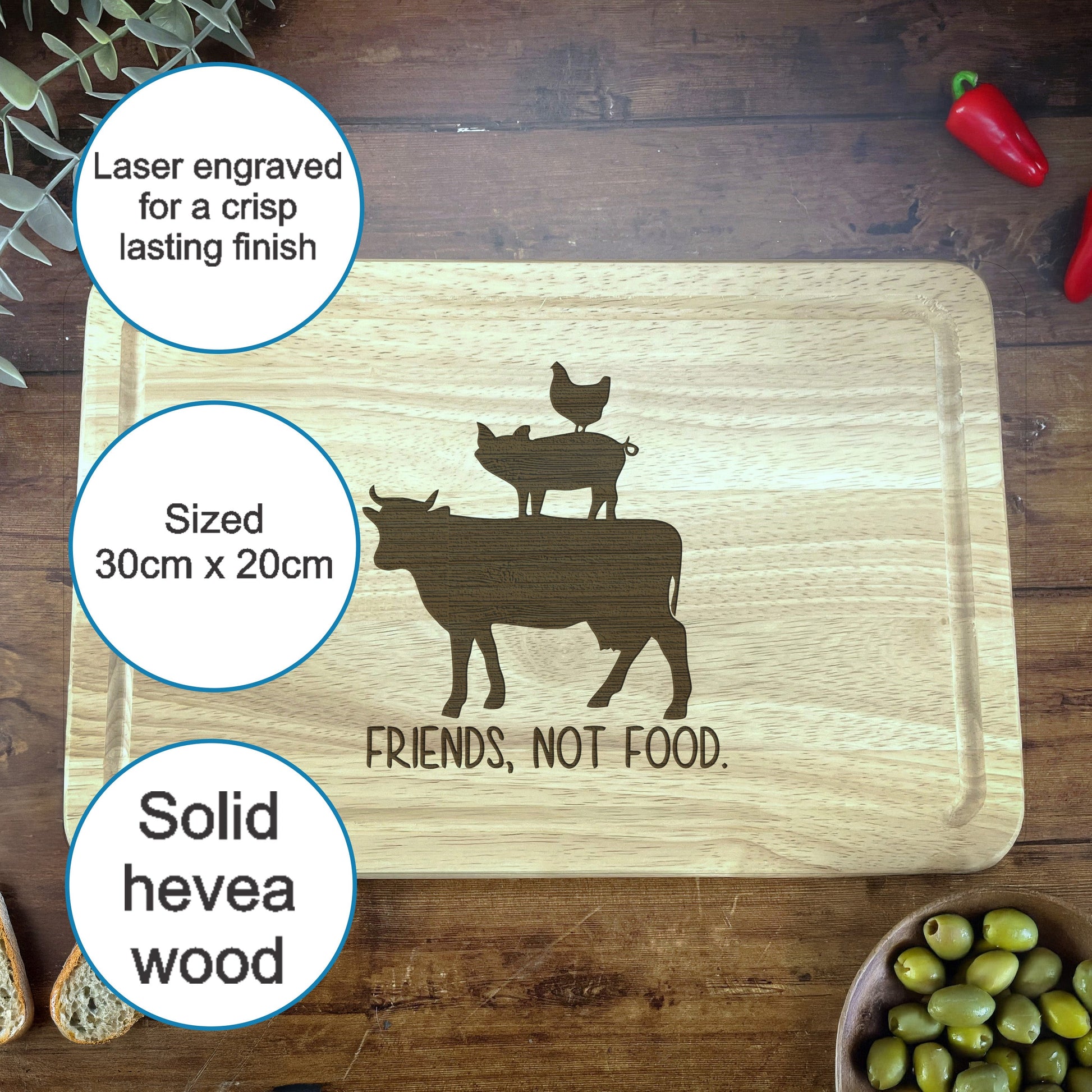 a cutting board with a picture of a cow and two chickens on it