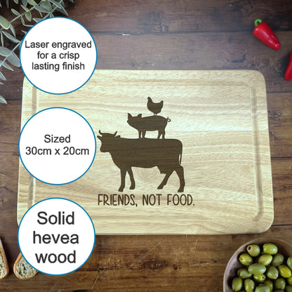 a cutting board with a picture of a cow and two chickens on it