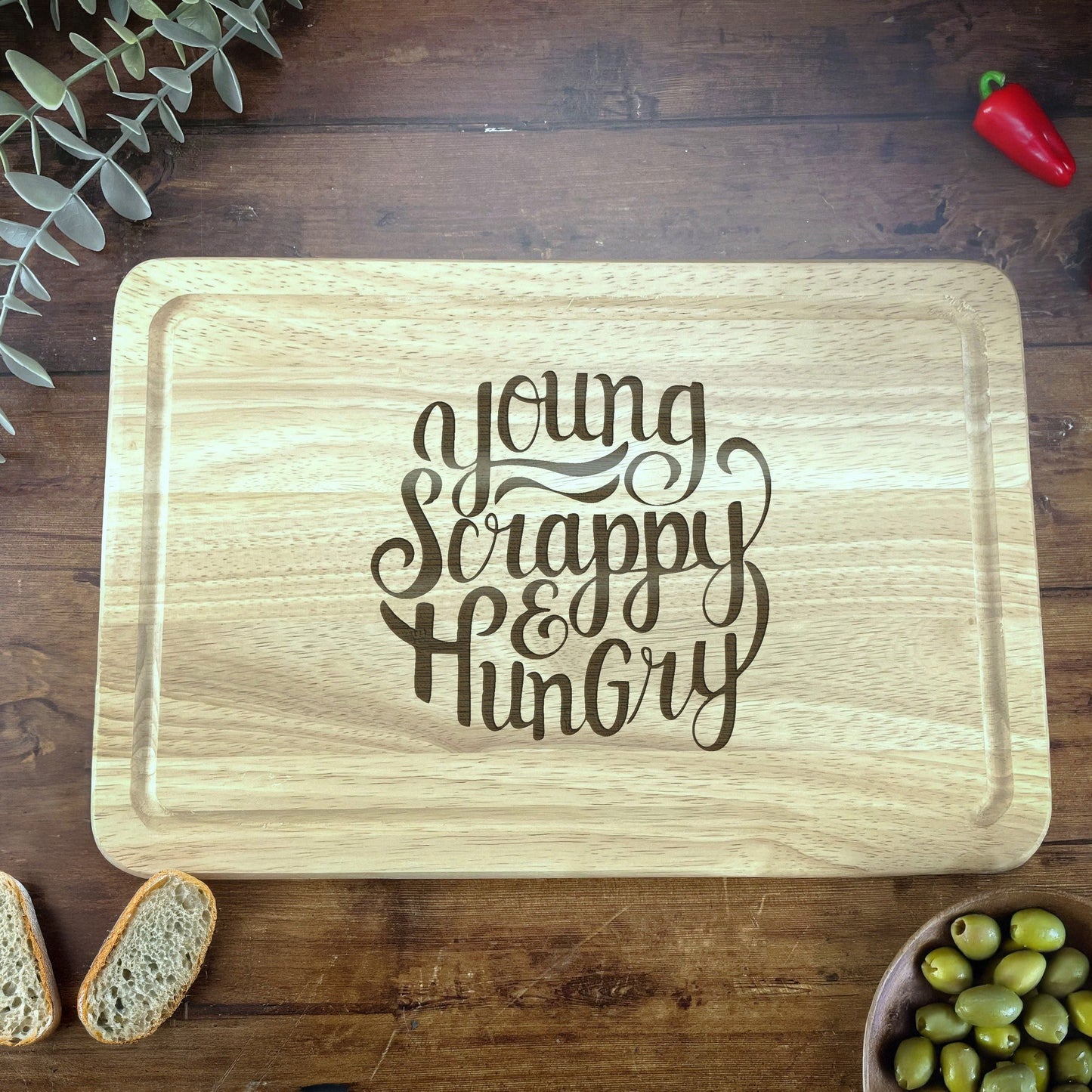 a wooden cutting board with a saying on it