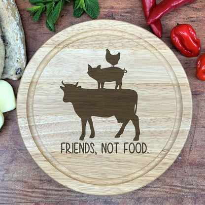 a cutting board with a picture of a cow and two chickens on it