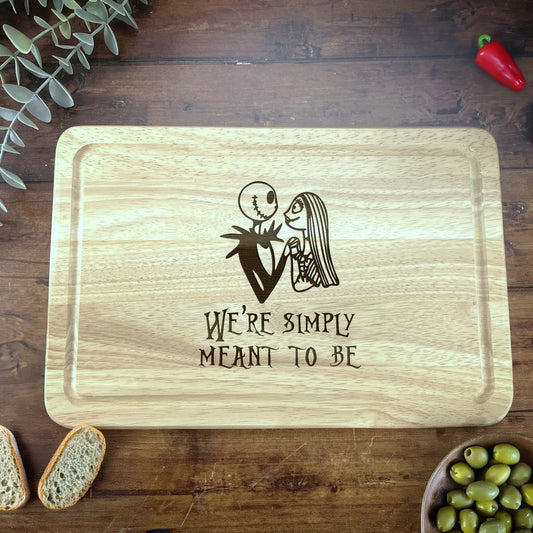 a wooden cutting board with a picture of a man and woman on it