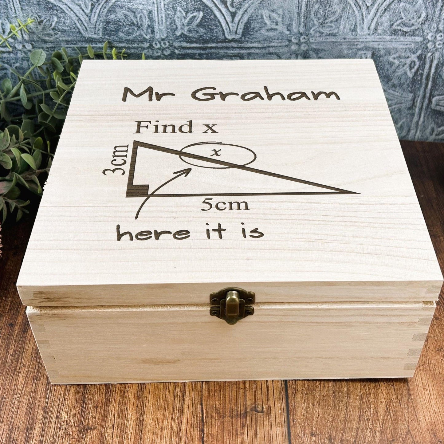 a wooden box sitting on top of a wooden table