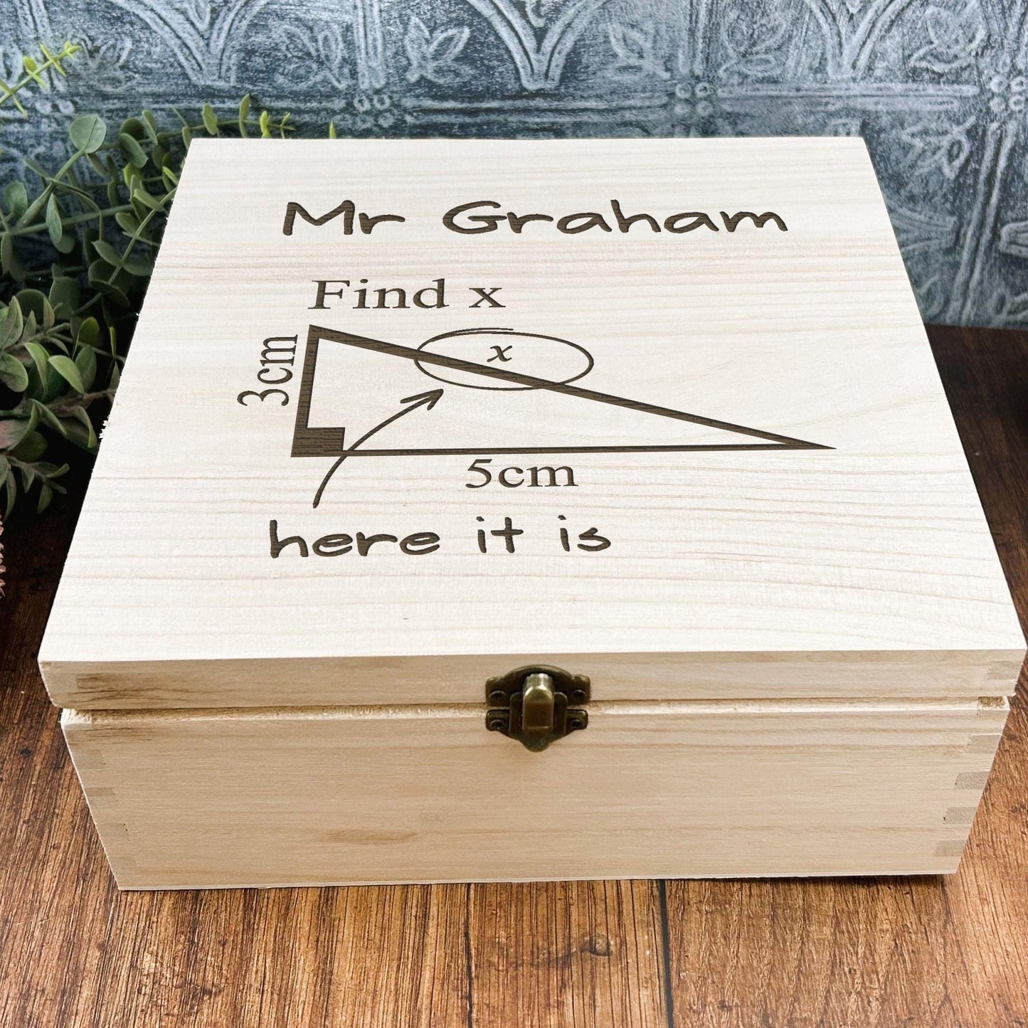 a wooden box sitting on top of a wooden table