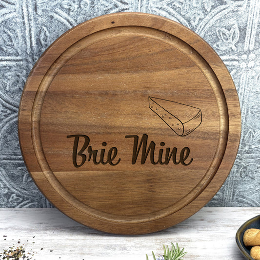 a wooden plate with the words brie mine on it