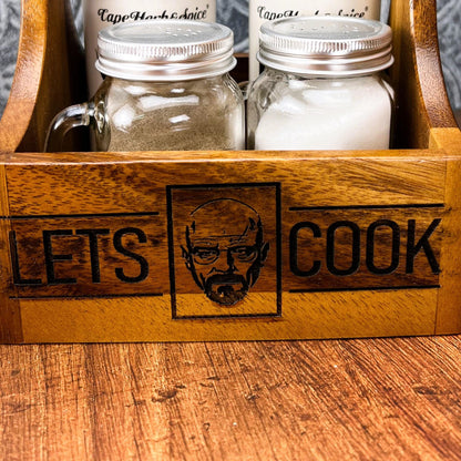 a wooden box with two jars of food inside of it
