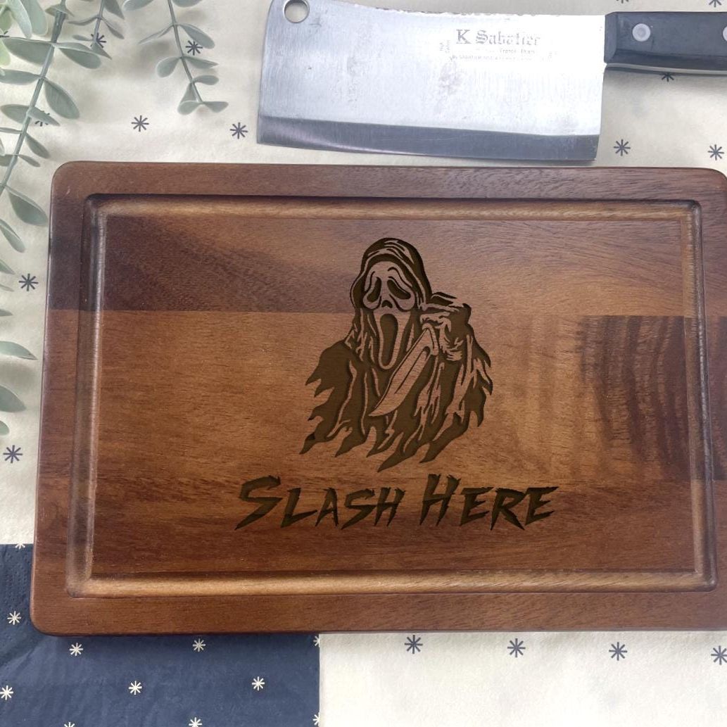 a wooden cutting board with a carving of a ghost