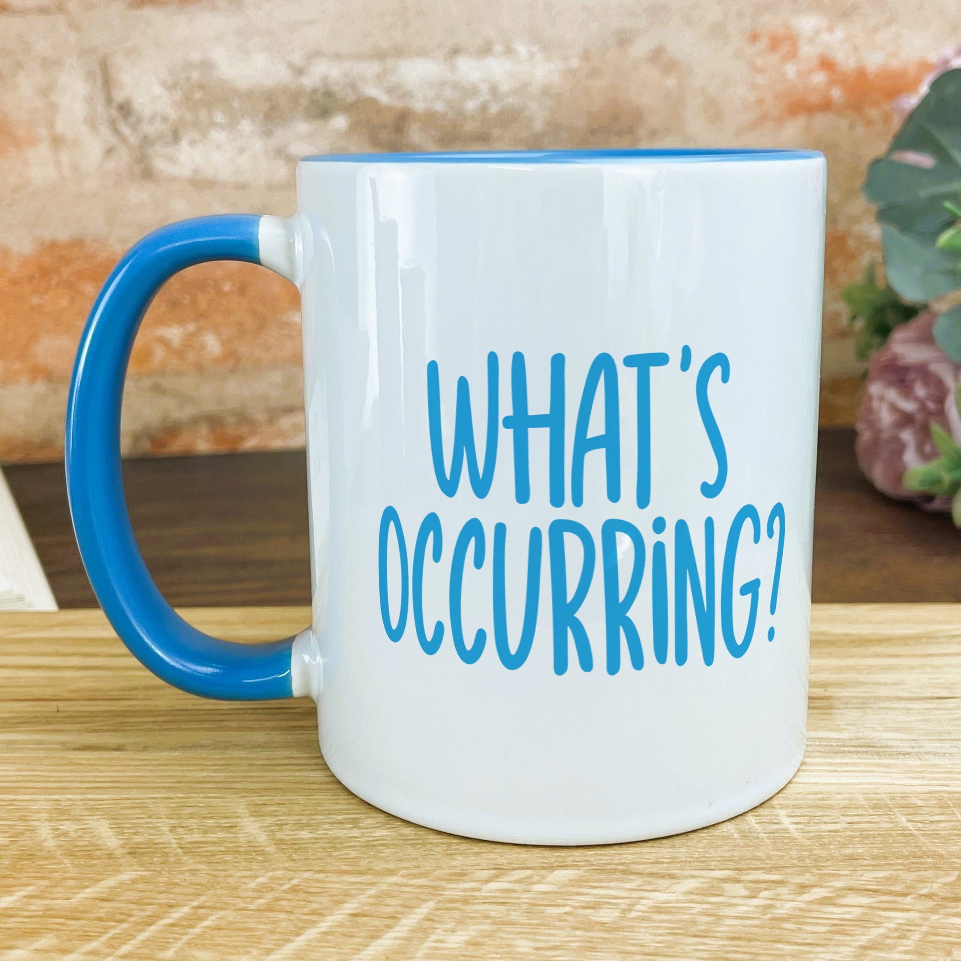 a blue and white coffee mug sitting on a table