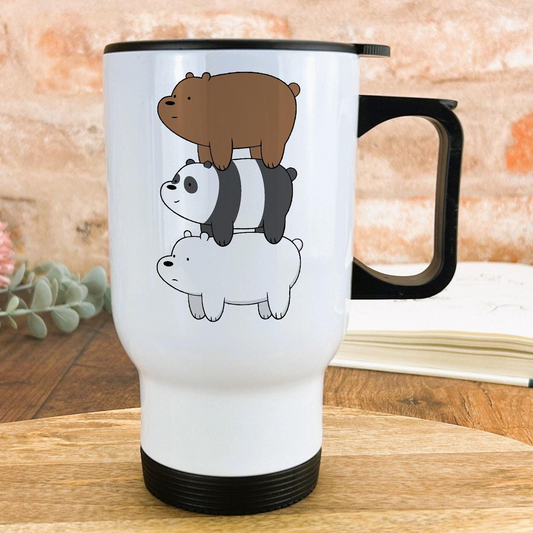 A white travel mug with a black handle, featuring a cartoon illustration of three cartoon bears stacked on top of each other.