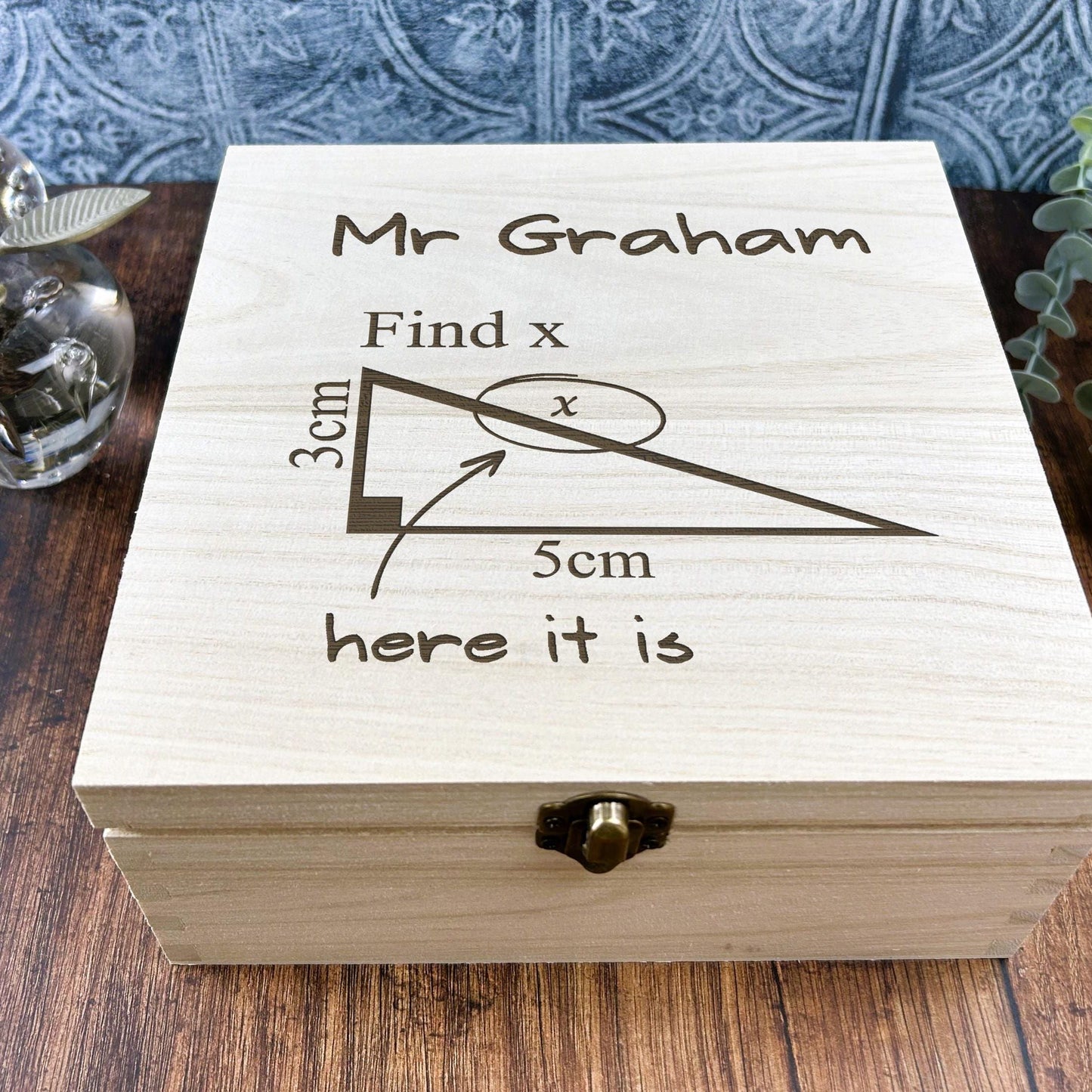 a wooden box sitting on top of a wooden table