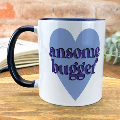 a blue and white coffee mug with the words awesome bugger on it