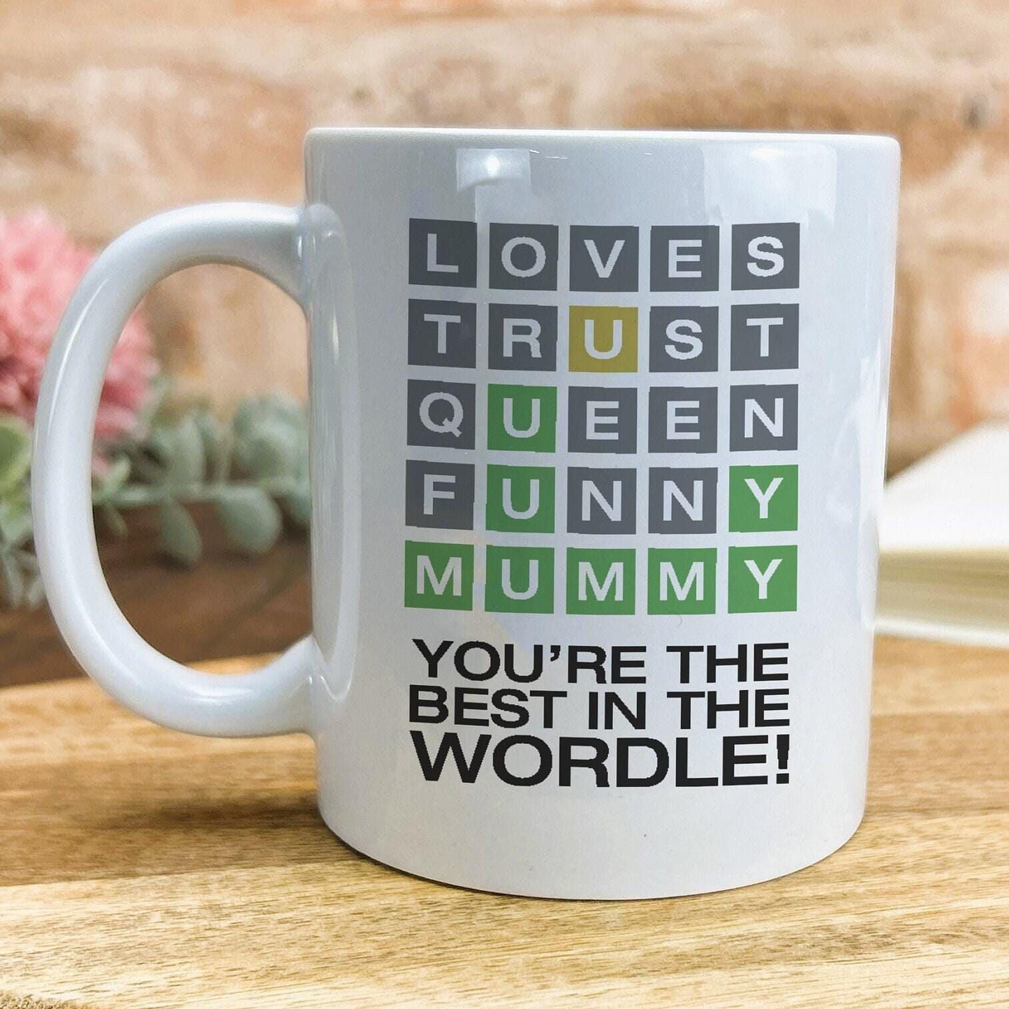 A white ceramic mug with a message printed on it.