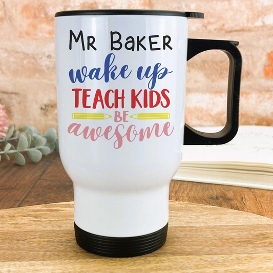 A white travel mug with text printed on it, placed on a wooden surface.