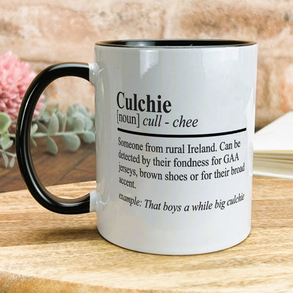 a black and white coffee mug on a wooden table