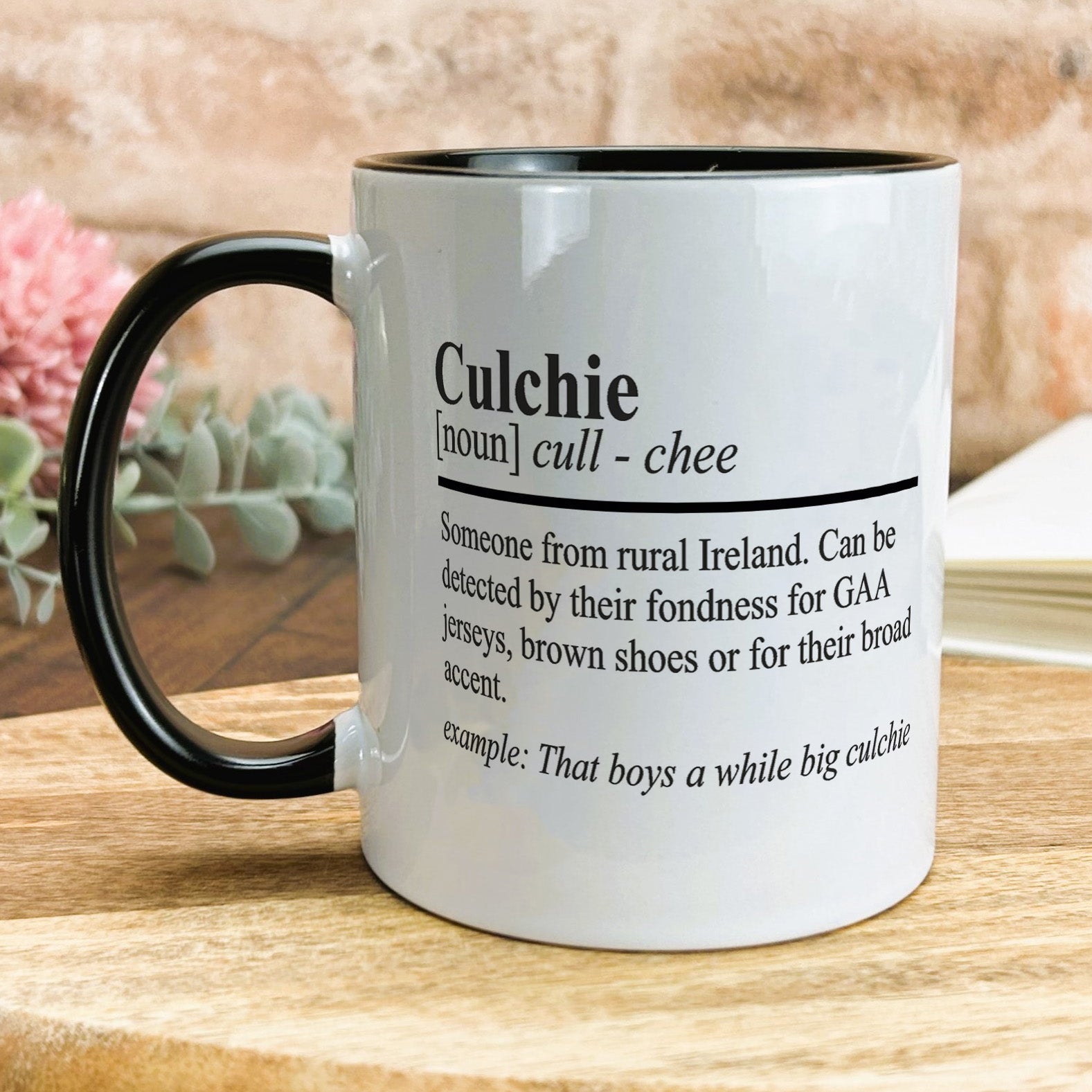 a black and white coffee mug on a wooden table