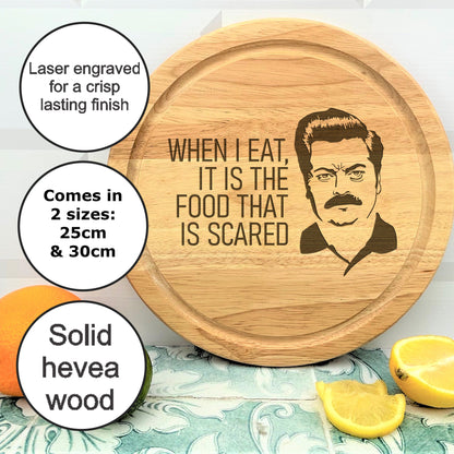 a wooden cutting board with a picture of a man on it
