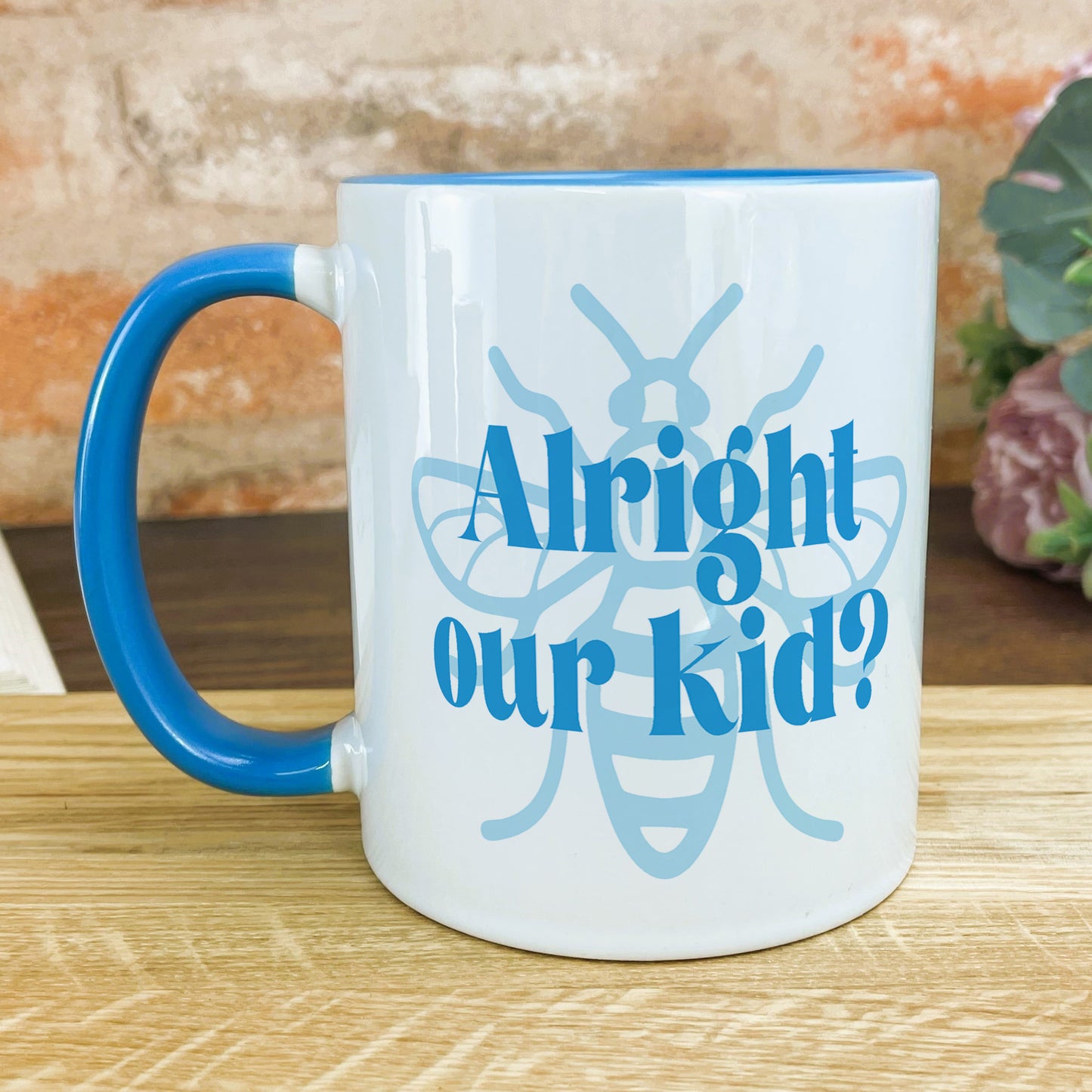 a blue and white coffee mug sitting on top of a wooden table