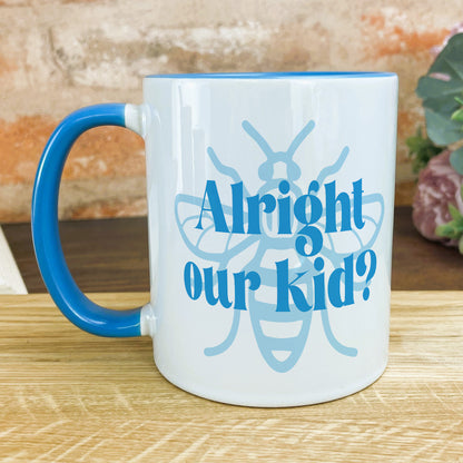 a blue and white coffee mug sitting on top of a wooden table