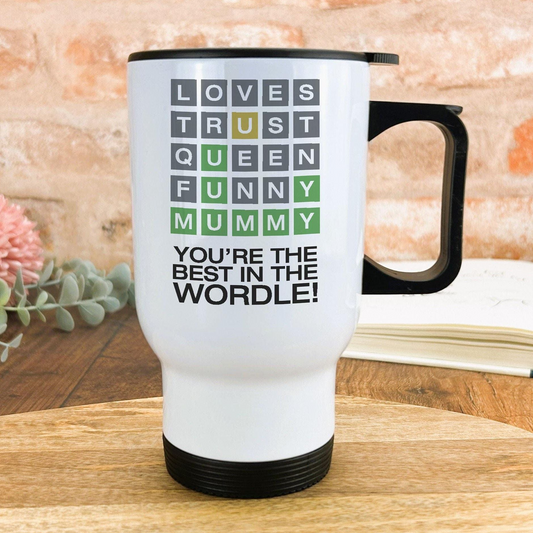 A white travel mug with a black handle, featuring a message that reads "YOU'RE THE BEST IN THE WORD! YOU'RE THE QUEEN IN THE MUMMY".