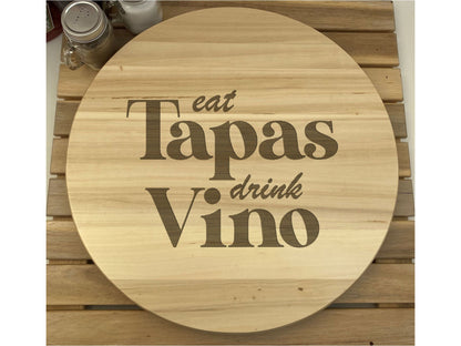 a wooden sign that says eat tapas drink vino