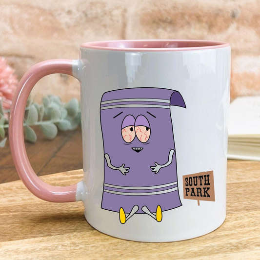 A white mug with a pink handle, featuring a cartoon character resembling a towel from the South Park television series.