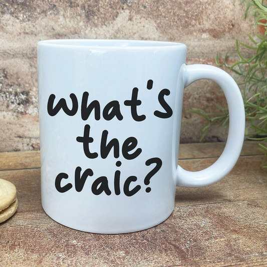 A white ceramic mug with the text "what's the craic?" printed on it.