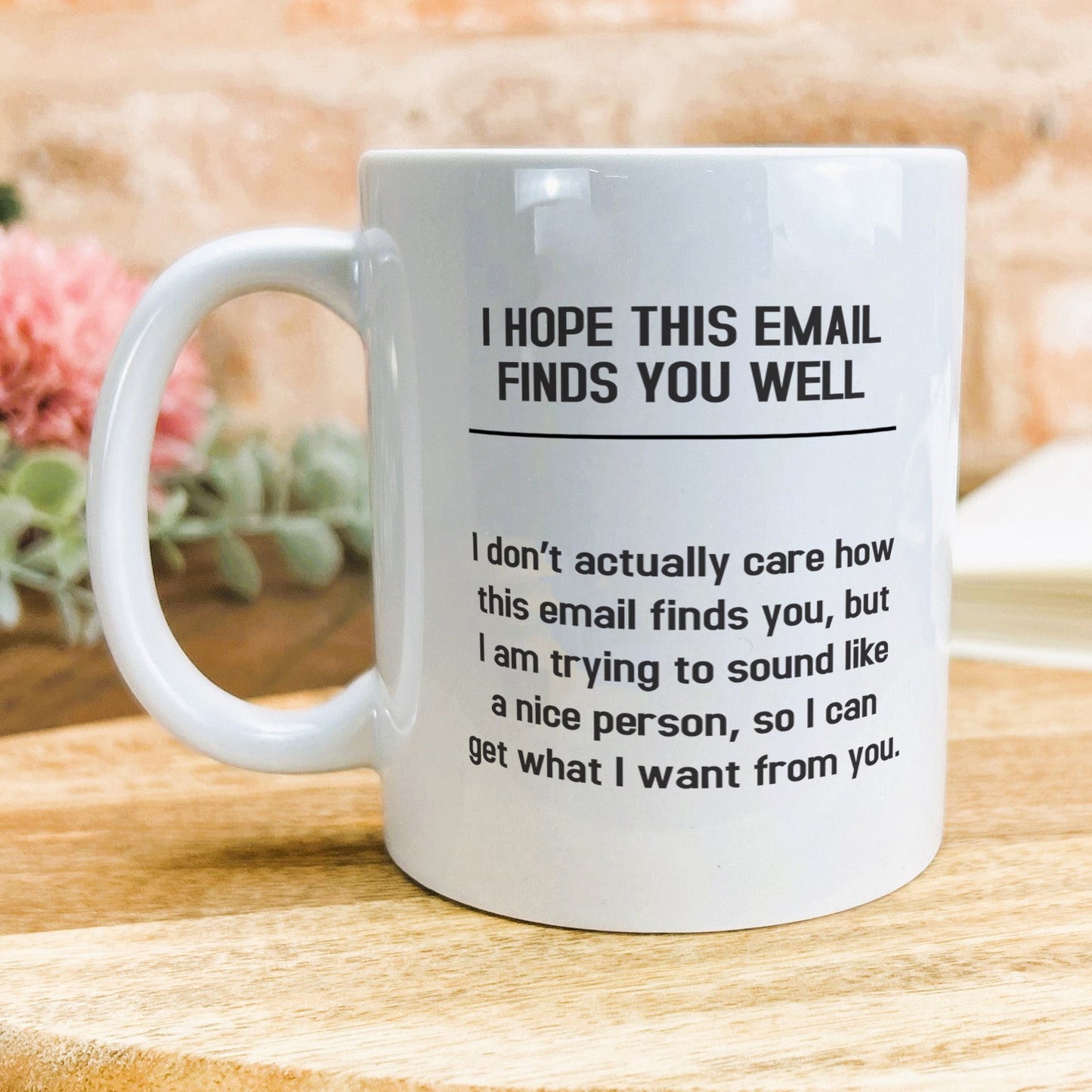 a white coffee mug sitting on top of a wooden table