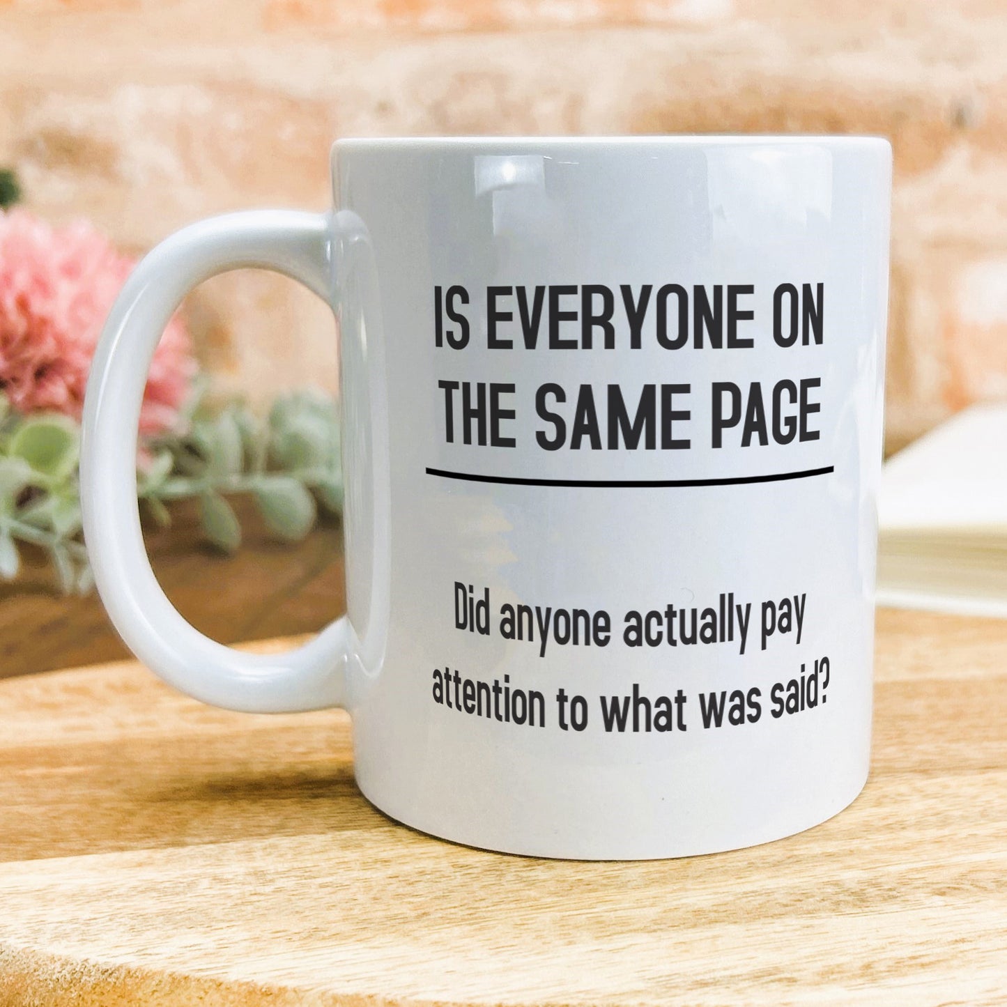 a white coffee mug sitting on top of a wooden table