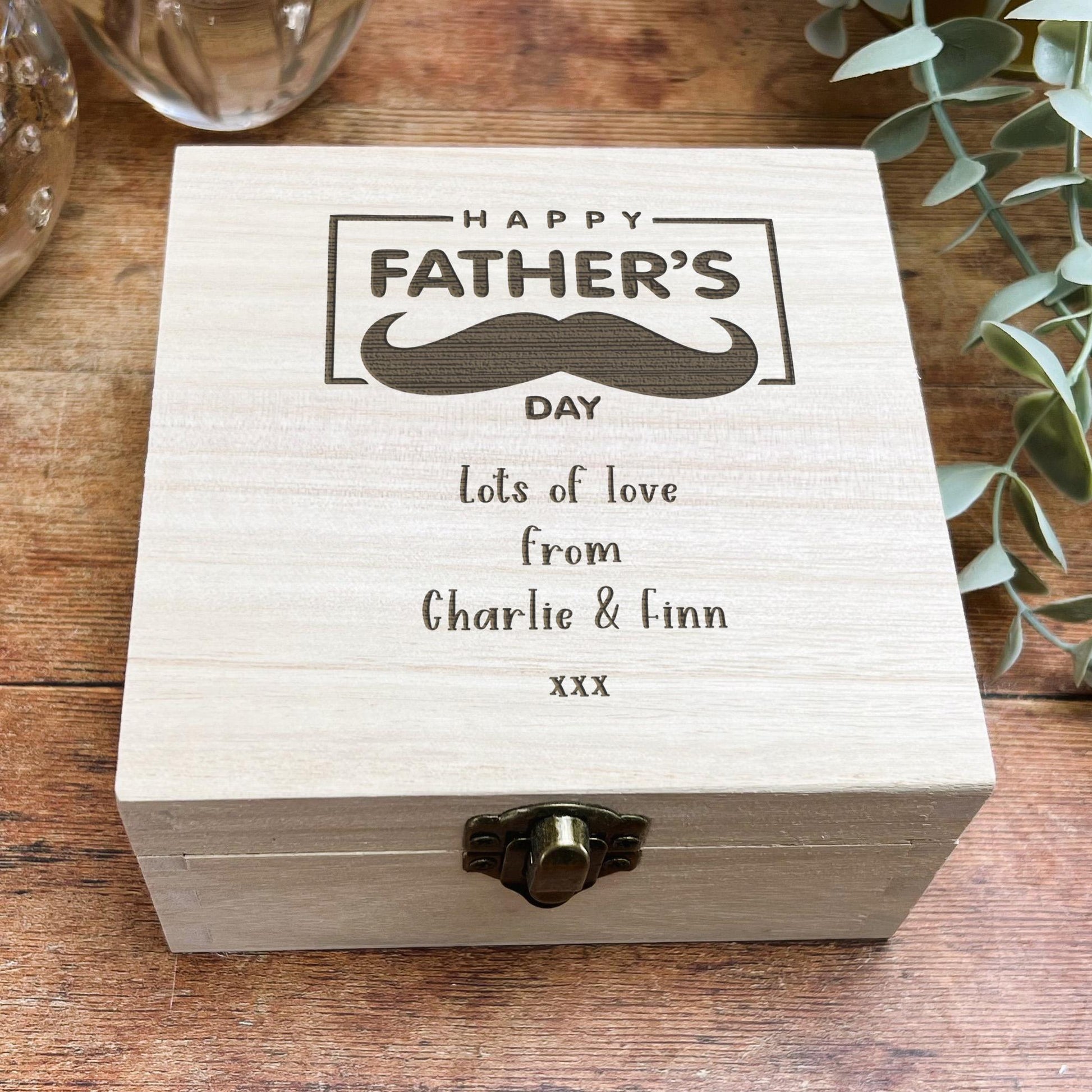 a wooden box with a picture of a mustache on it