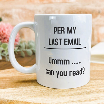 a white coffee mug sitting on top of a wooden table