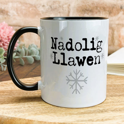 a black and white coffee mug sitting on top of a wooden table
