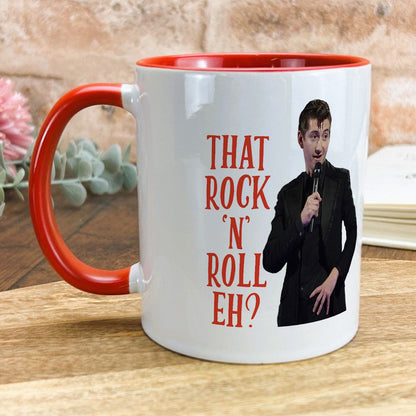 a red and white coffee mug with a picture of a man holding a microphone