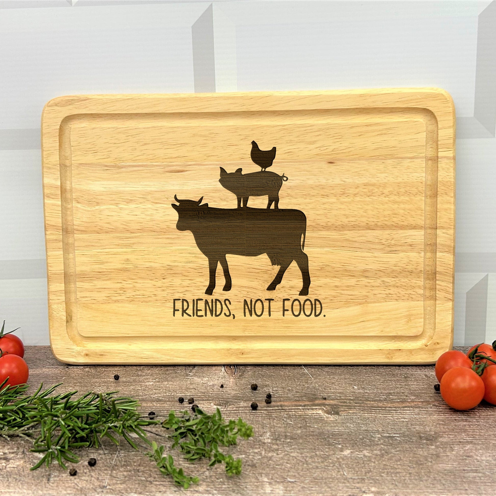 a cutting board with a picture of a cow and chickens on it