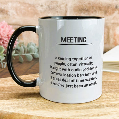 a black and white coffee mug sitting on top of a wooden table