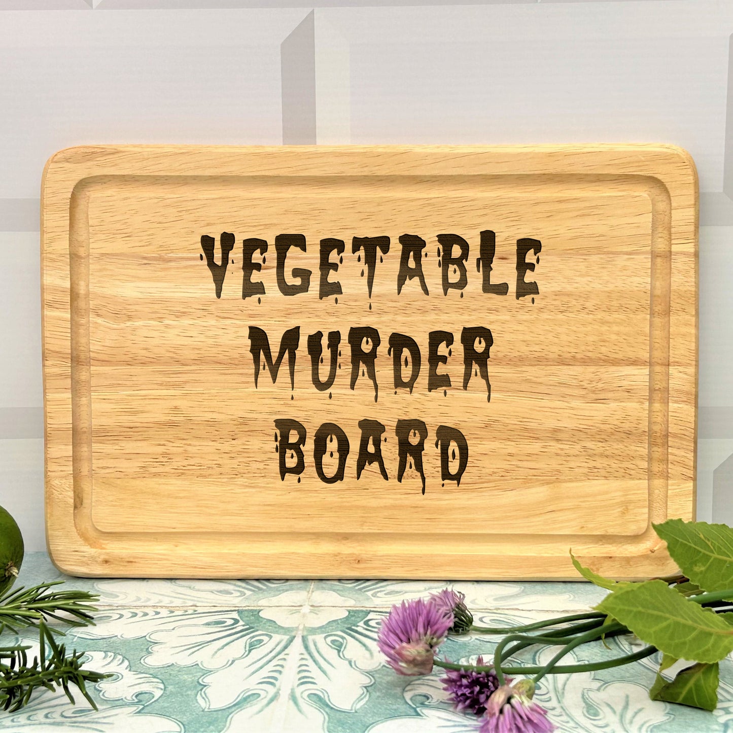 a wooden sign that says vegetable murder board