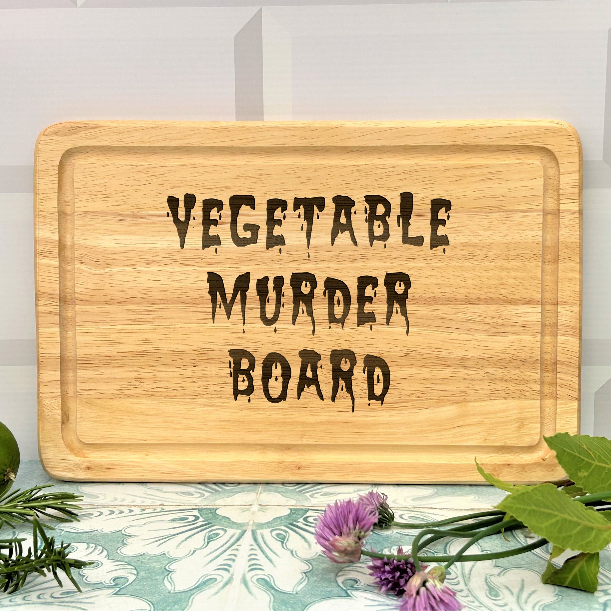a wooden sign that says vegetable murder board