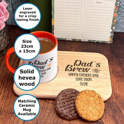 A wooden tray with a mug, a note pad, and two cookies on a table.