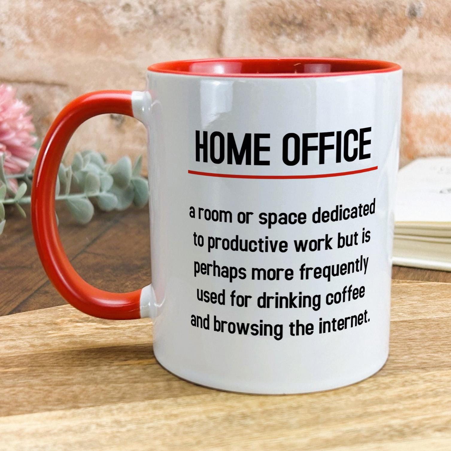 a red and white coffee mug sitting on top of a wooden table