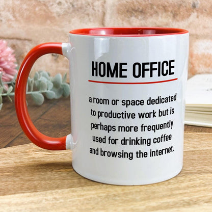 a red and white coffee mug sitting on top of a wooden table