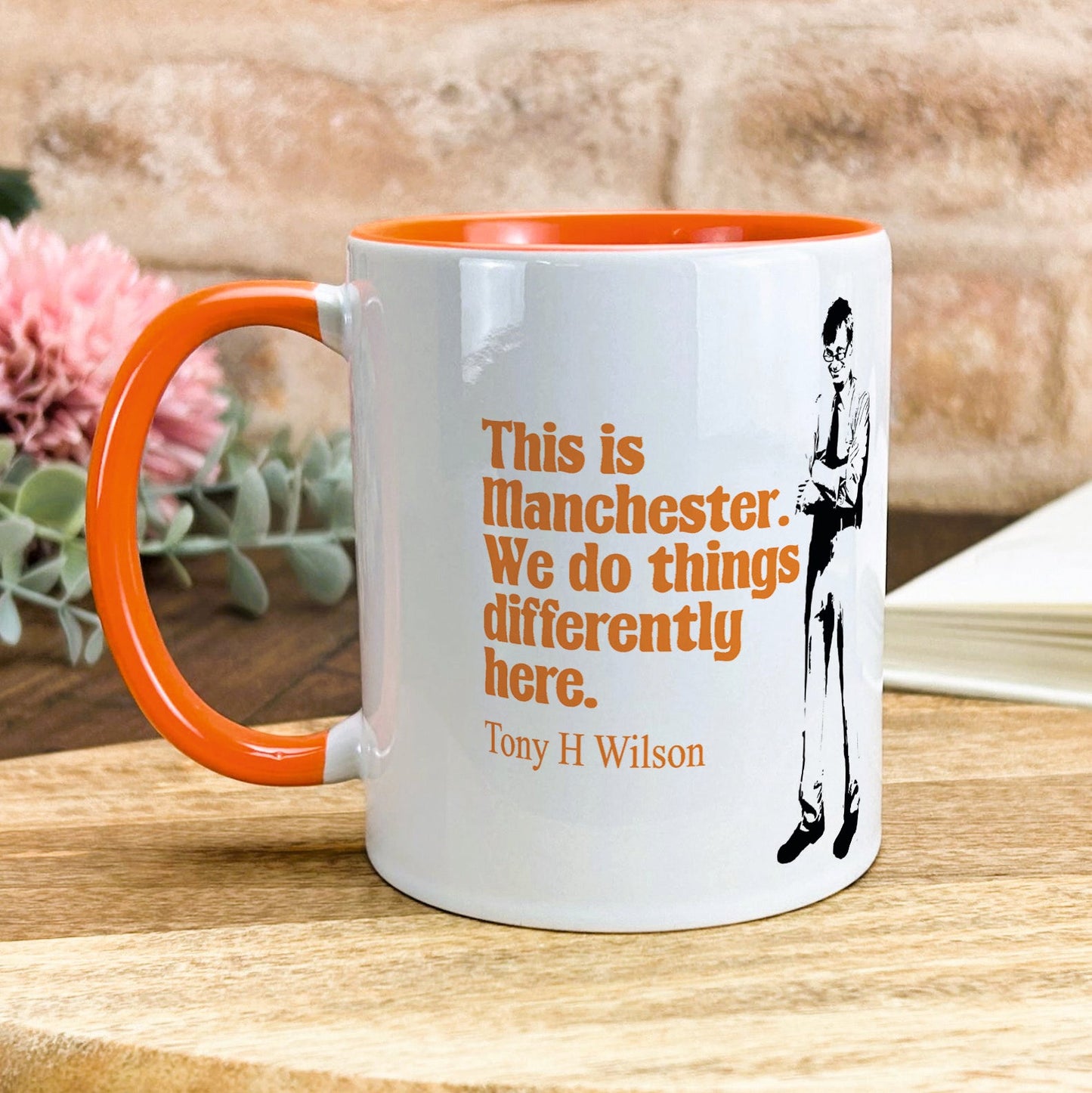 a white and orange coffee mug sitting on a table