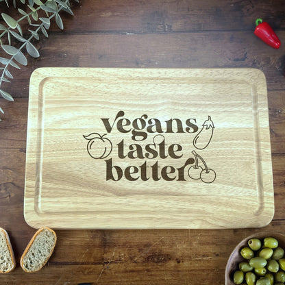 a cutting board that says vegans taste better next to a bowl of olives