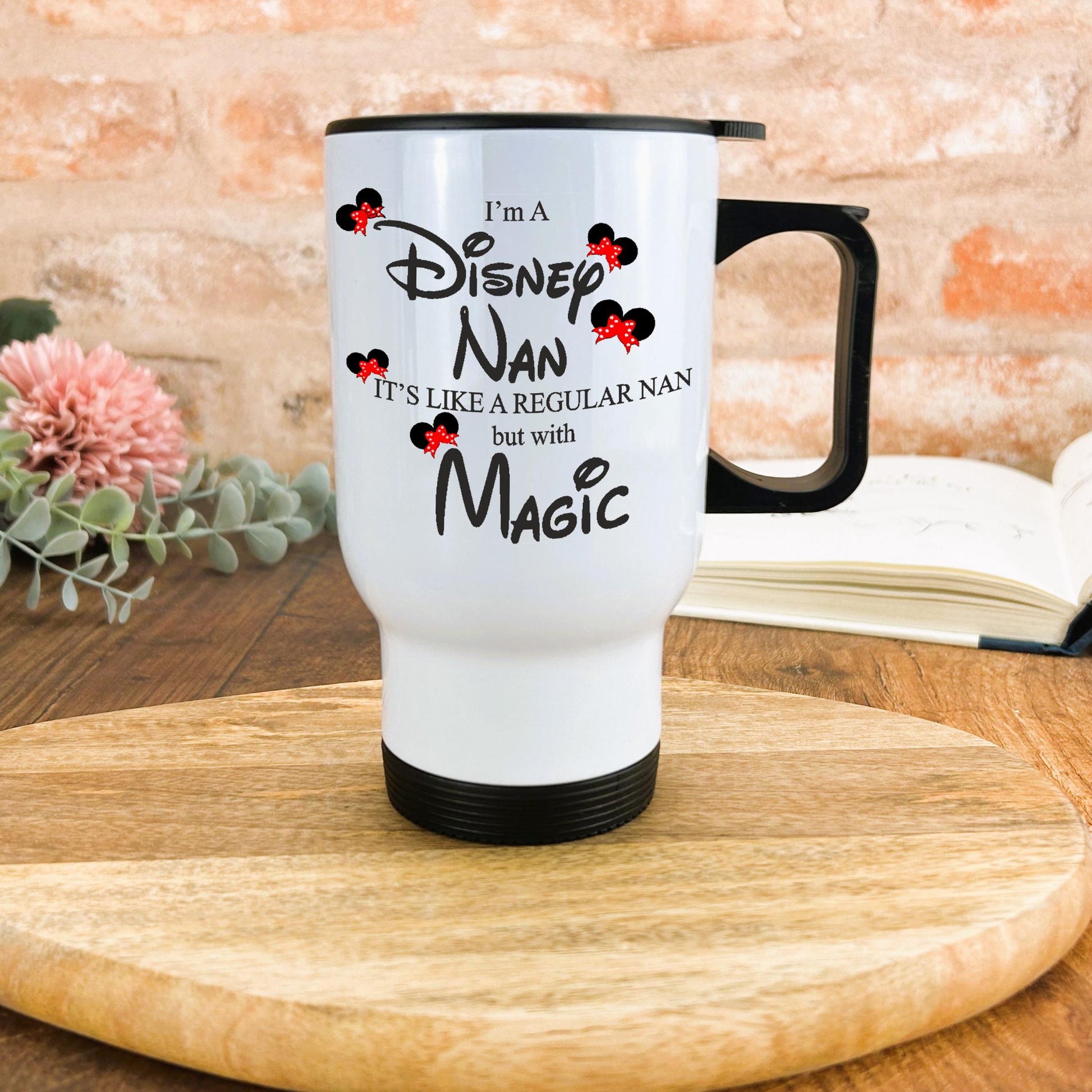 a white coffee mug sitting on top of a wooden table