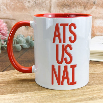 a red and white coffee mug with the words ats us nai on it