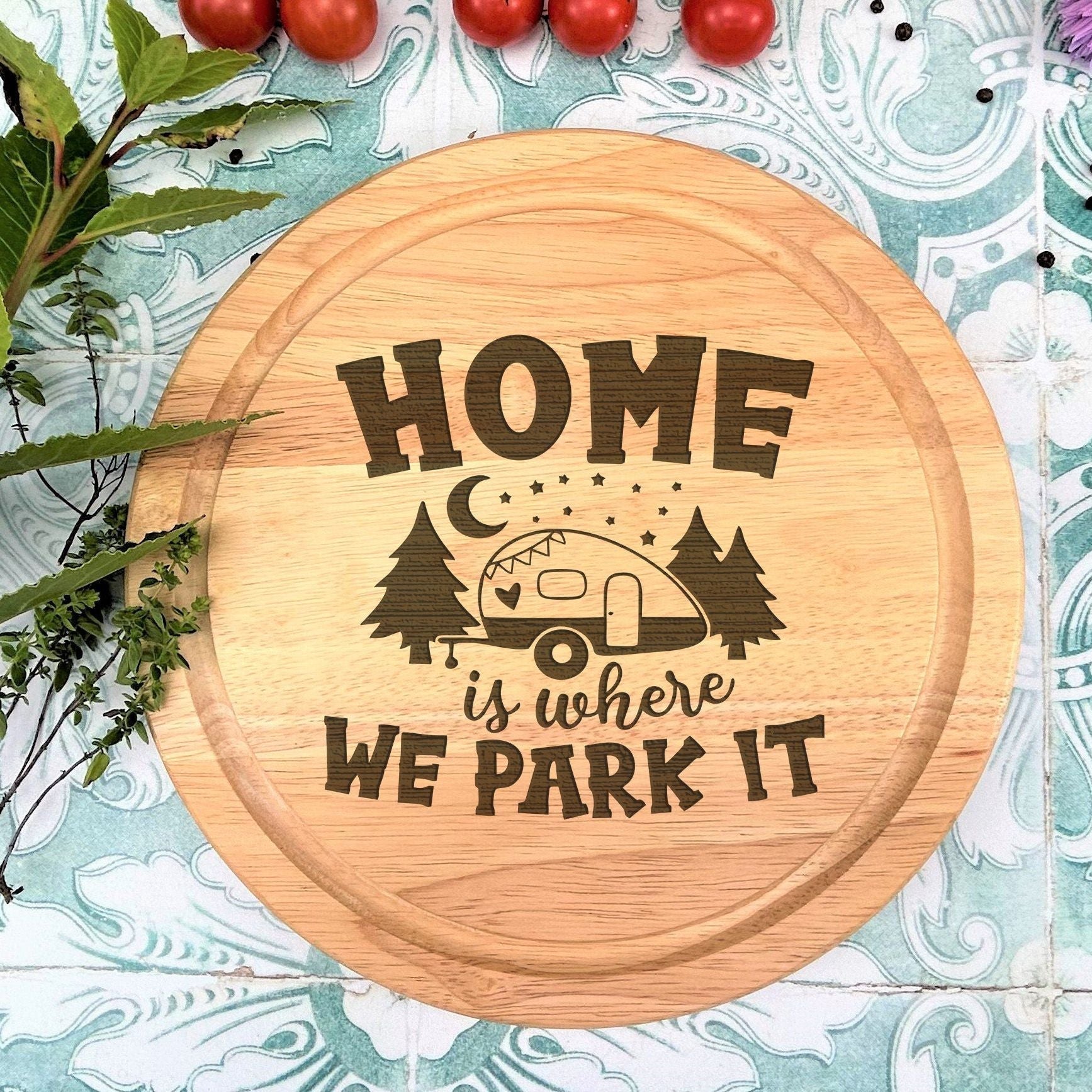 a wooden sign that says home is where we park it