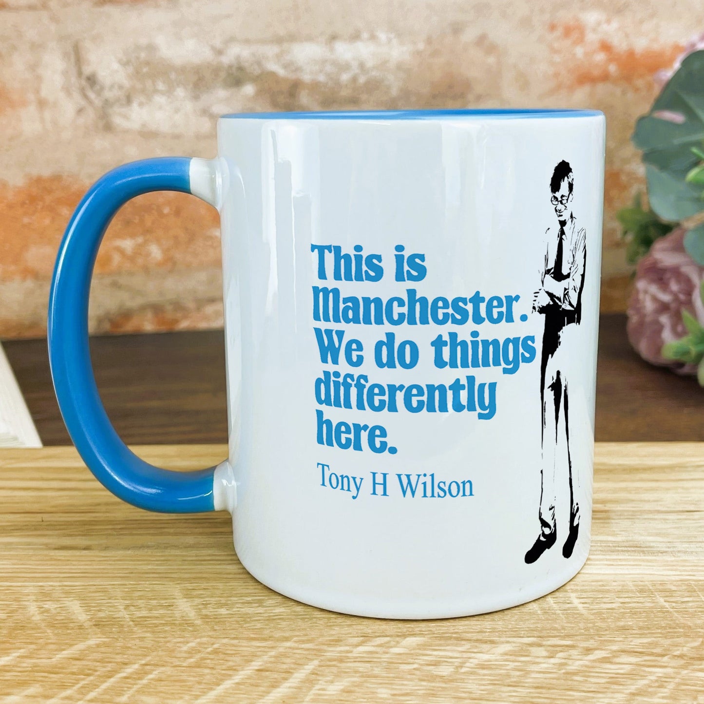 a blue and white coffee mug sitting on a table