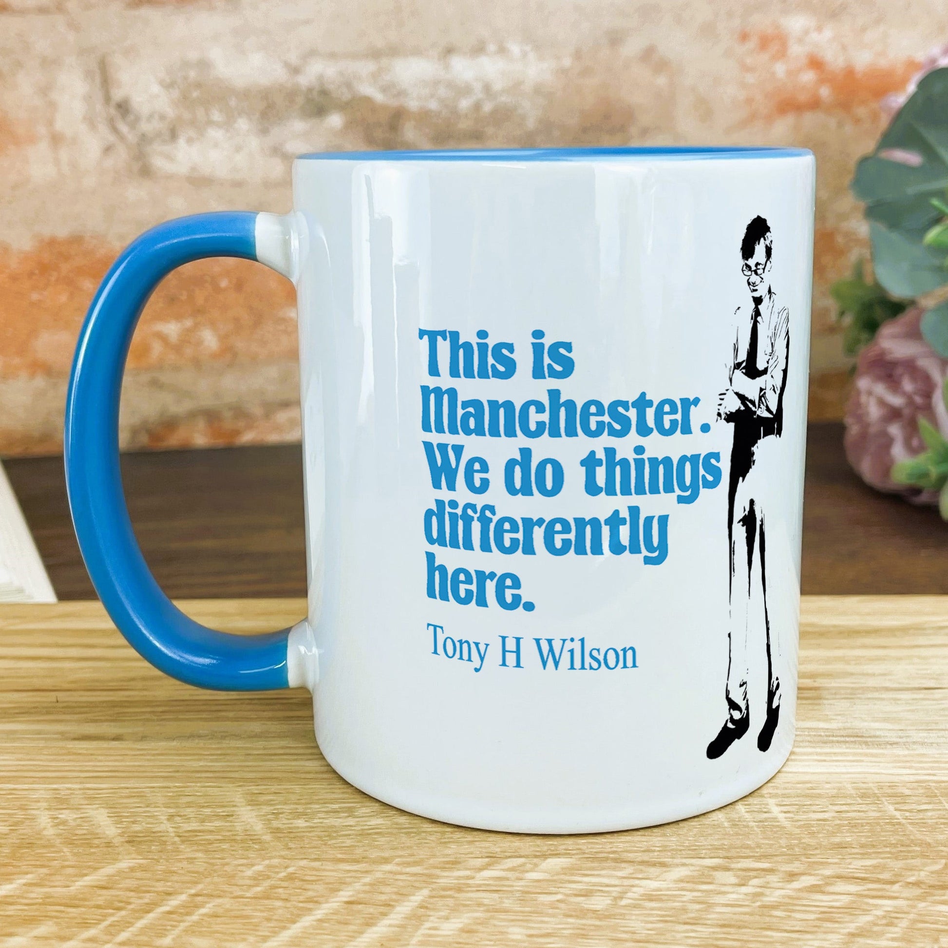 a blue and white coffee mug sitting on a table
