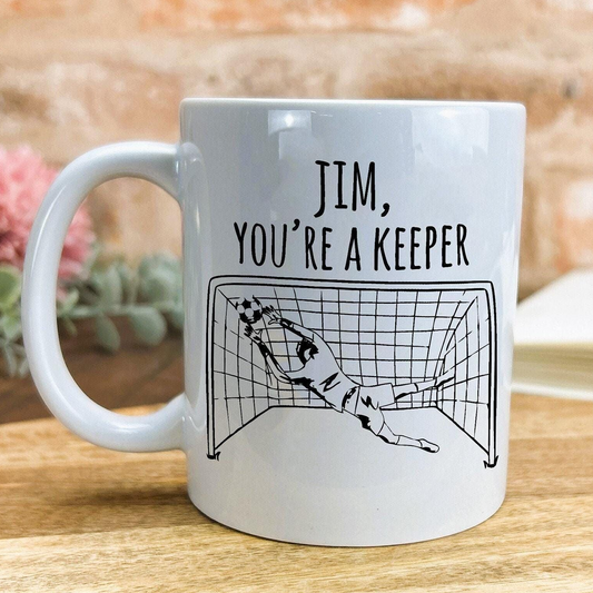 A white ceramic mug with a humorous text and graphic design on it.