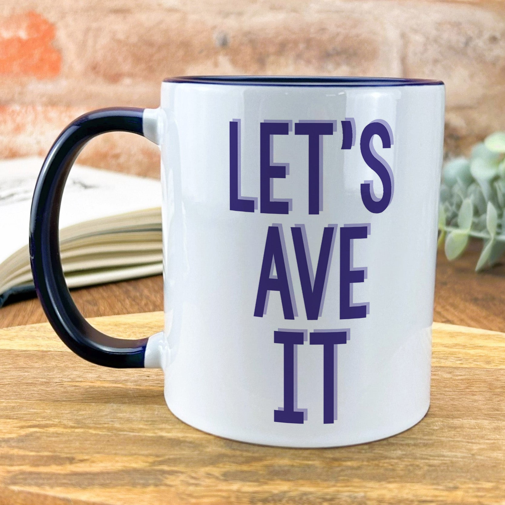 a black and white coffee mug that says let's ave it