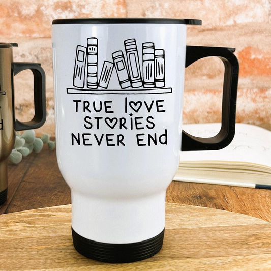 A white travel mug with a black handle and printed text that says "True love stories never end".
